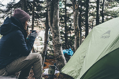 Person camping in the woods